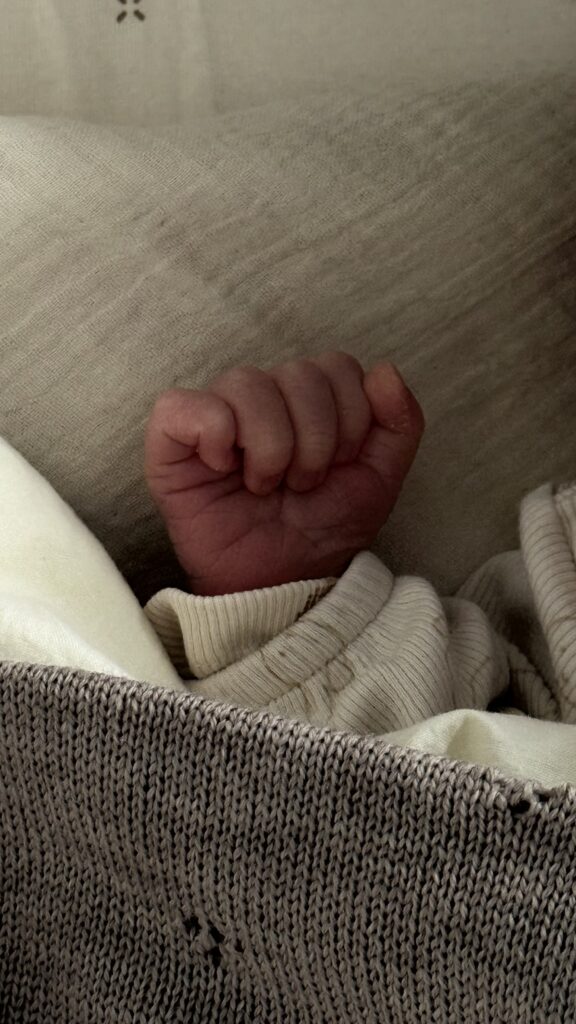 The tiny hand of newborn Davin